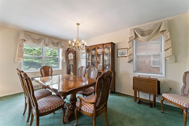 dining room with a chandelier and dark carpet