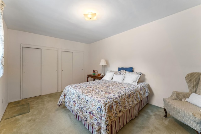 carpeted bedroom with multiple closets