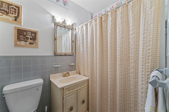 bathroom featuring vanity, a shower with curtain, tile walls, and toilet