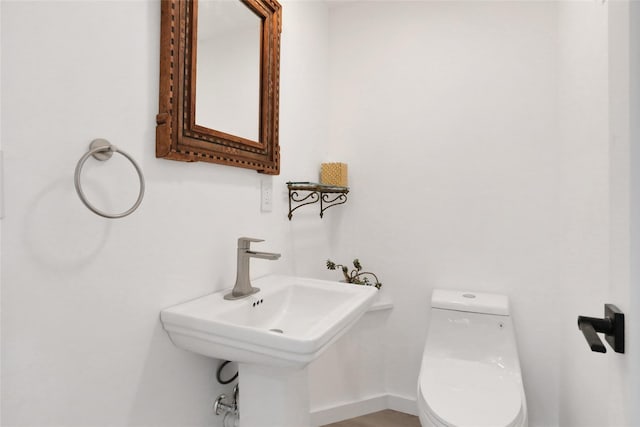 bathroom featuring sink and toilet