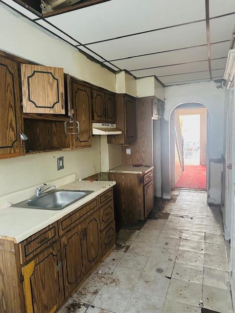 kitchen featuring sink and dark brown cabinets