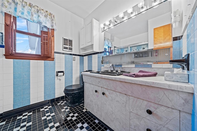 bathroom featuring tile walls, toilet, and vanity