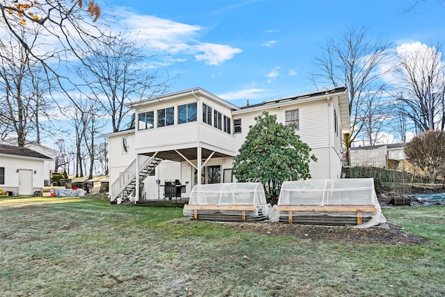 back of property with an outdoor structure and a yard