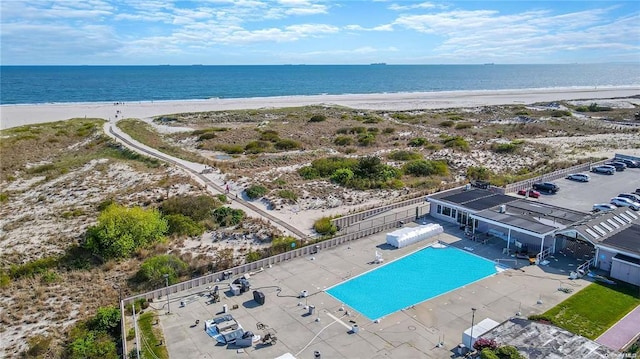 bird's eye view featuring a water view and a view of the beach