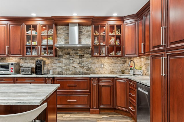 kitchen with sink, dishwasher, backsplash, light stone counters, and wall chimney exhaust hood