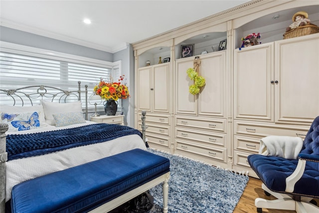 bedroom with crown molding, wood finished floors, and recessed lighting