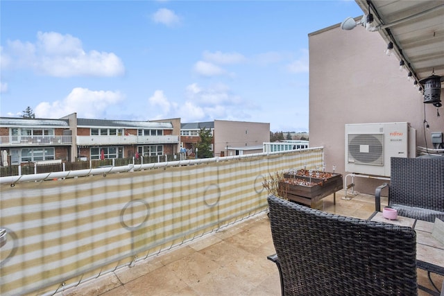 balcony with a cooling unit and a patio