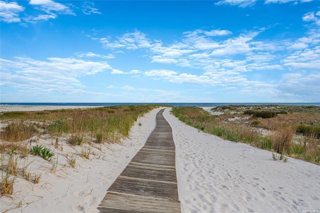 view of community featuring view of water and beach