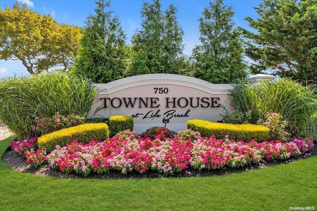 community / neighborhood sign with a lawn