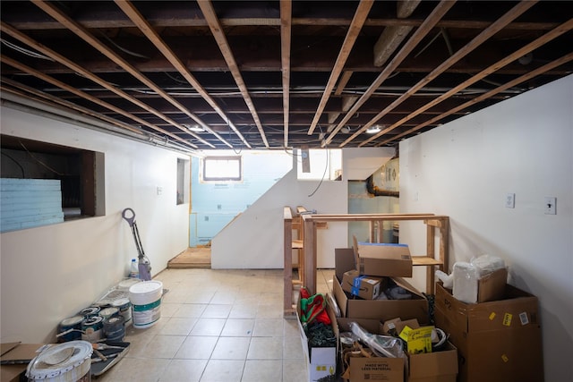 basement with light tile patterned flooring