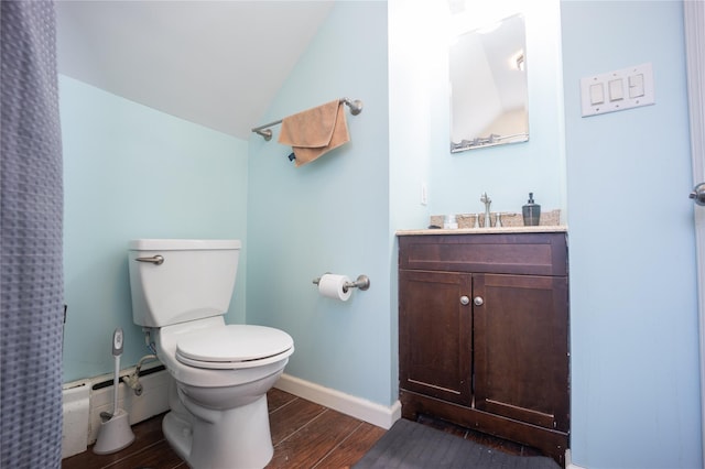 bathroom featuring baseboard heating, hardwood / wood-style floors, toilet, vanity, and lofted ceiling