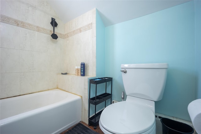 bathroom featuring plus walk in shower, toilet, and lofted ceiling