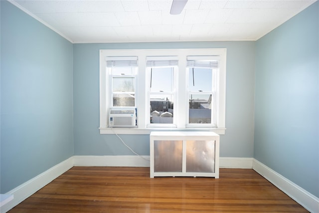 unfurnished room with cooling unit and wood-type flooring