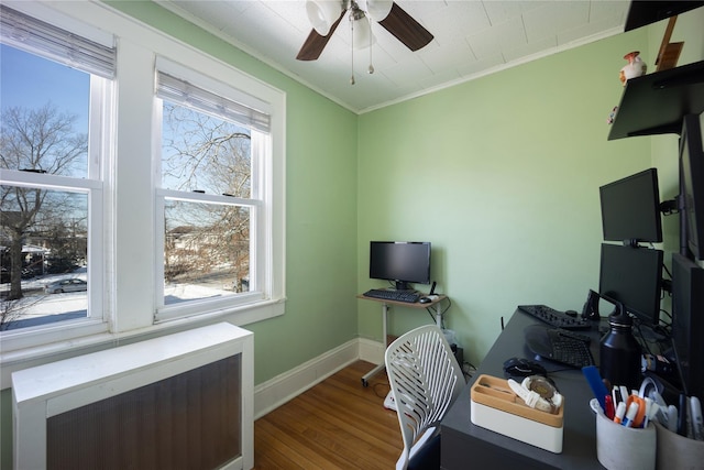 office area featuring ceiling fan, hardwood / wood-style floors, radiator, and ornamental molding