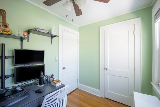 office area with crown molding, light hardwood / wood-style floors, and ceiling fan