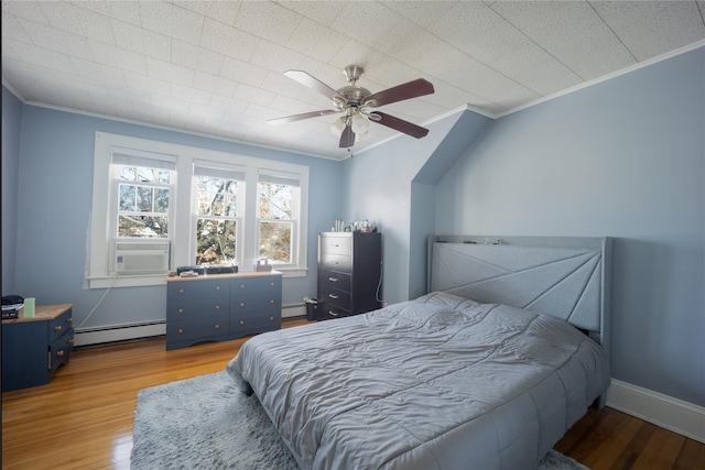 bedroom featuring ceiling fan, crown molding, a baseboard radiator, and wood-type flooring