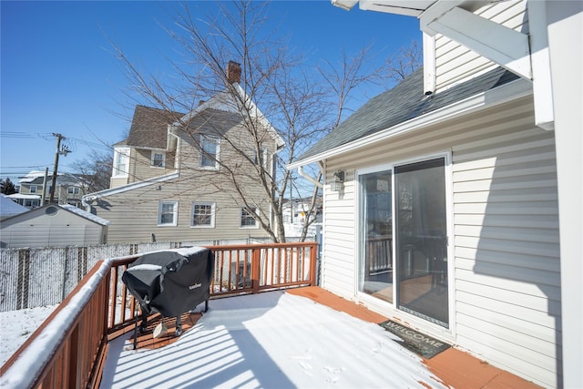 snow covered deck featuring area for grilling