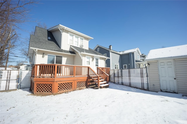 snow covered rear of property featuring a wooden deck