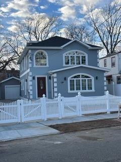 147-26 240th St, Rosedale, NY 11422 - view of front facade featuring a garage and an outbuilding