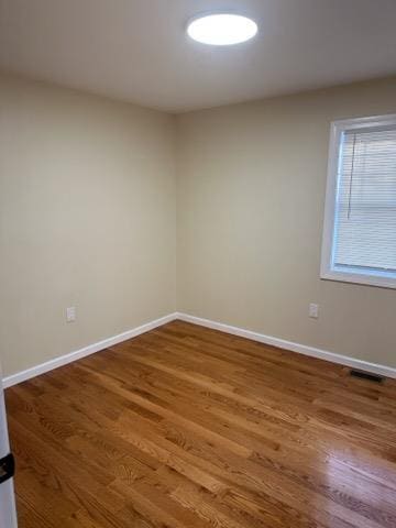 unfurnished room featuring wood-type flooring