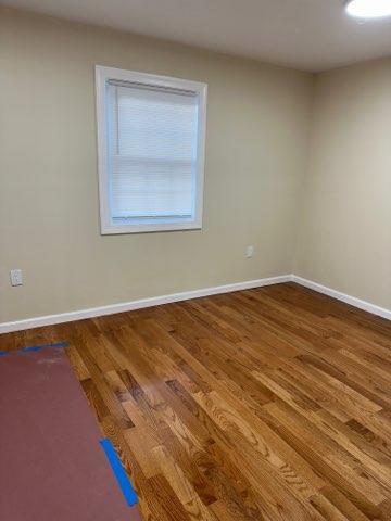 unfurnished room featuring wood-type flooring