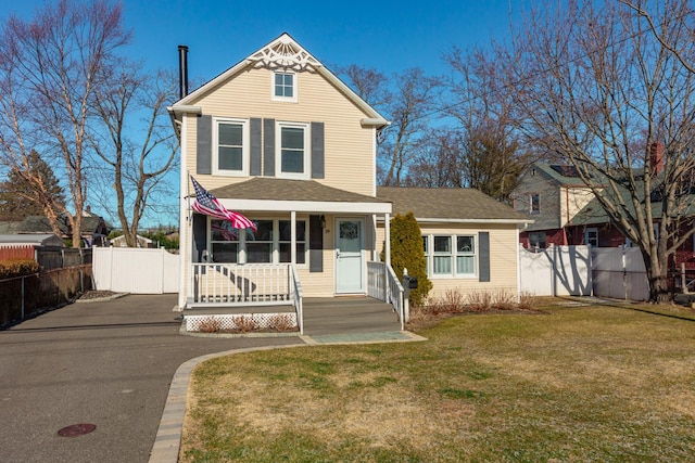 view of front facade with a front lawn and a porch