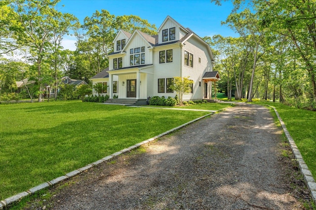 16 Hampton St, Westhampton Beach, NY 11978 - view of front of house featuring board and batten siding, dirt driveway, and a front yard