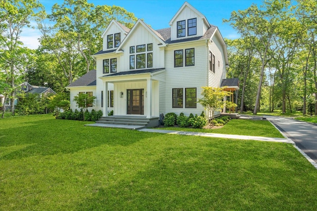 16 Hampton St, Westhampton Beach, NY 11978 - view of front of house with board and batten siding, a front lawn, and roof with shingles
