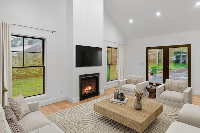 16 Hampton St, Westhampton Beach, NY 11978 - living room featuring high vaulted ceiling, recessed lighting, plenty of natural light, light wood-type flooring, and french doors