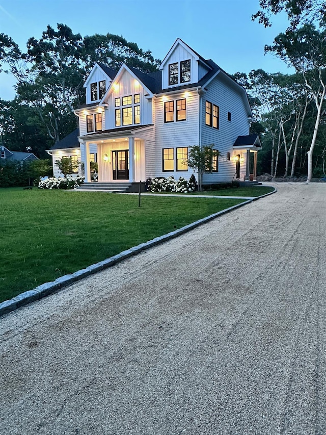 16 Hampton St, Westhampton Beach, NY 11978 - view of front of home with board and batten siding, a front yard, a porch, and driveway