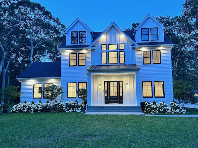 16 Hampton St, Westhampton Beach, NY 11978 - view of front facade featuring a front yard, board and batten siding, and a standing seam roof