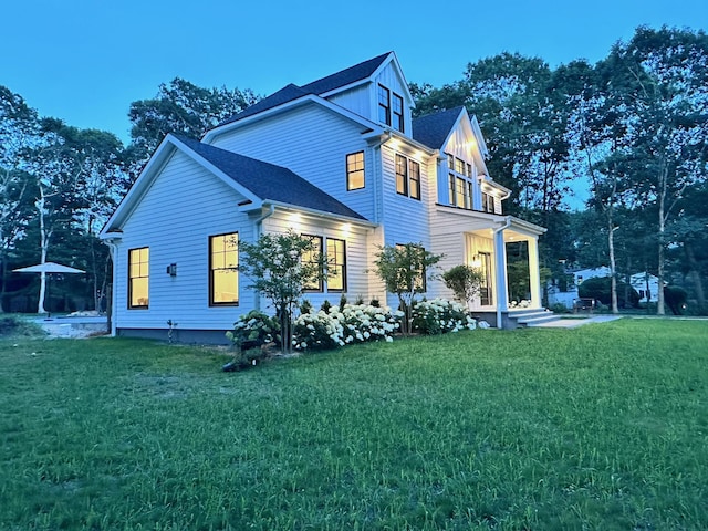 16 Hampton St, Westhampton Beach, NY 11978 - view of side of home featuring a lawn