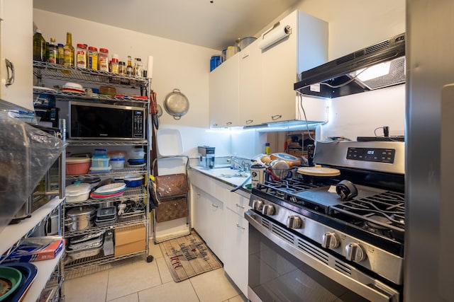 kitchen featuring white cabinetry, sink, stainless steel range with gas stovetop, and light tile patterned flooring