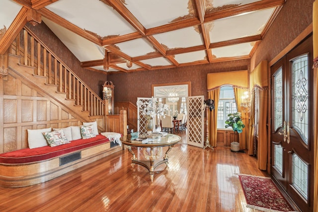 entryway with french doors, wood-type flooring, coffered ceiling, and beamed ceiling