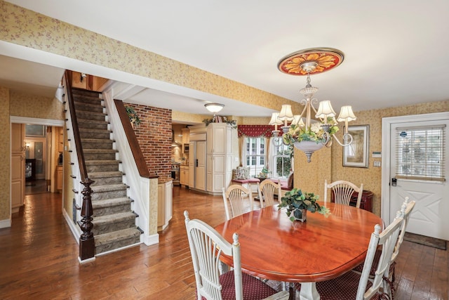 dining area with a healthy amount of sunlight, dark hardwood / wood-style floors, and a chandelier