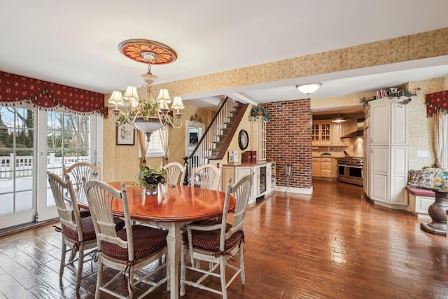 dining area with wood-type flooring and a chandelier