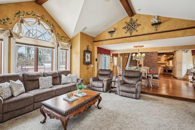 living room featuring a notable chandelier, beam ceiling, high vaulted ceiling, and carpet