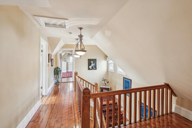 corridor featuring lofted ceiling and dark wood-type flooring