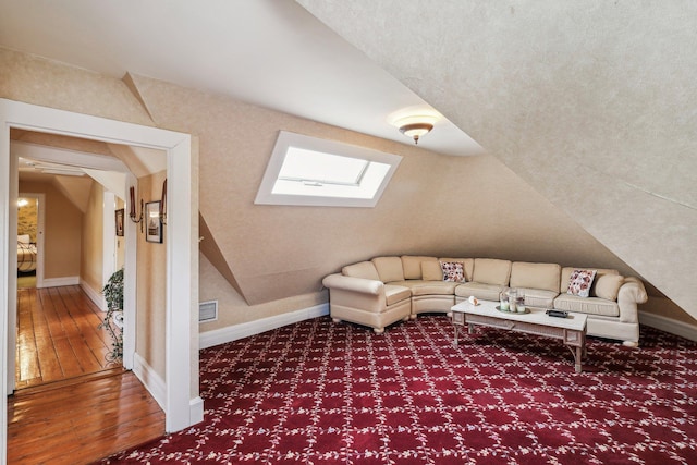 interior space featuring hardwood / wood-style flooring and a skylight