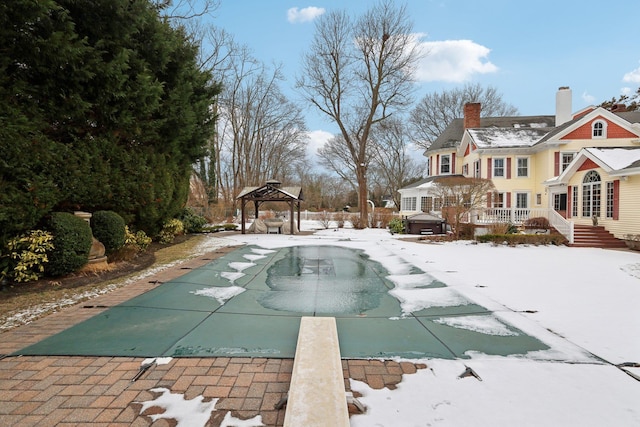 exterior space with a wooden deck, a gazebo, a diving board, and a jacuzzi