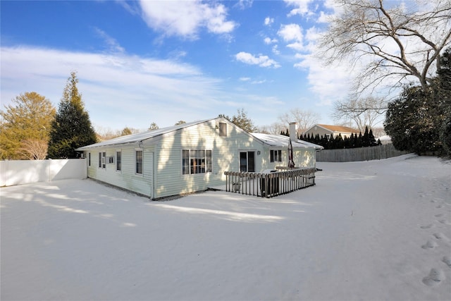 view of side of property featuring a wooden deck