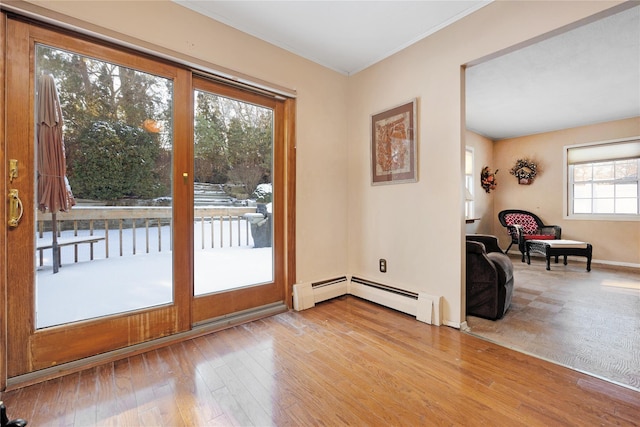 doorway to outside with light hardwood / wood-style flooring and baseboard heating