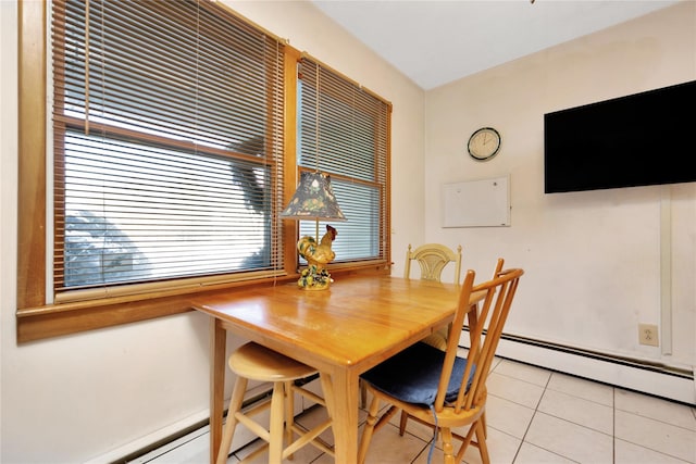 dining space featuring light tile patterned flooring and baseboard heating