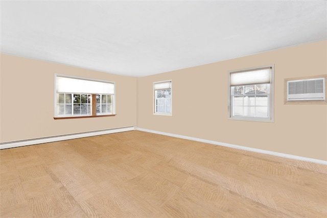 unfurnished room with plenty of natural light, a wall mounted AC, and baseboard heating