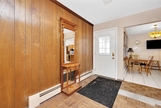 entryway featuring parquet flooring, a baseboard radiator, and wood walls