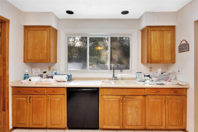 kitchen featuring light tile patterned flooring, black dishwasher, and sink