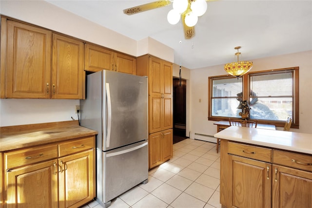 kitchen with stainless steel refrigerator, a baseboard radiator, light tile patterned floors, and pendant lighting