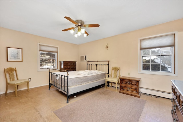 bedroom with ceiling fan and a baseboard heating unit