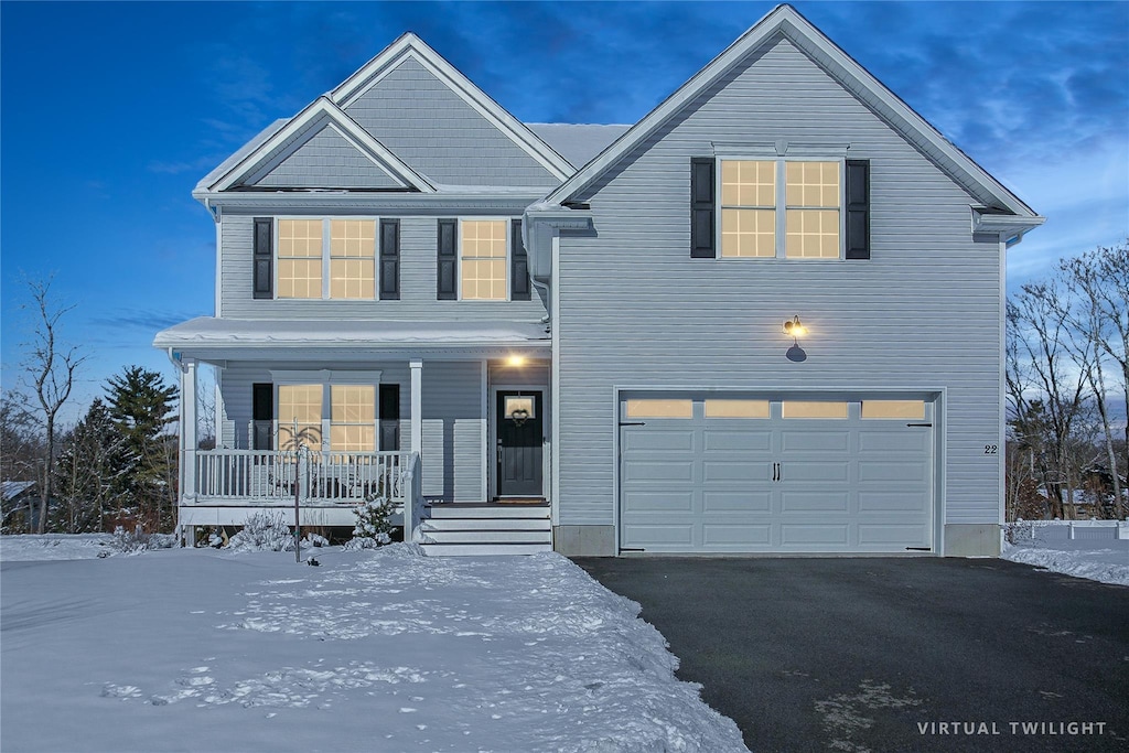 view of front of property with a garage and covered porch