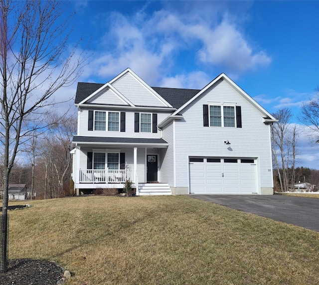 view of front facade featuring a garage, a porch, and a front lawn